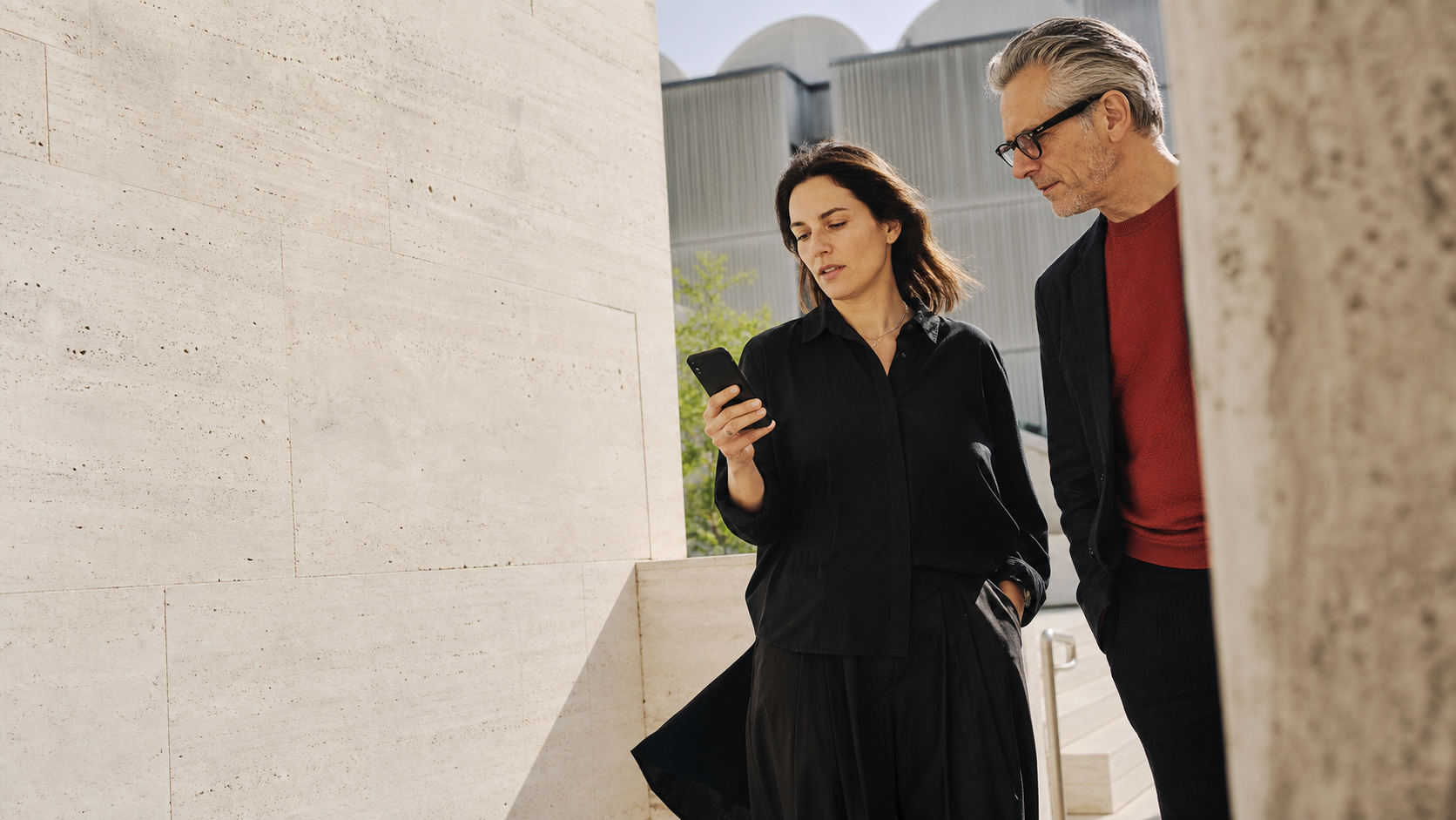 Product leaders reviewing an application while walking through a sunlit space